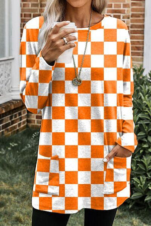 a woman wearing an orange and white checkered top