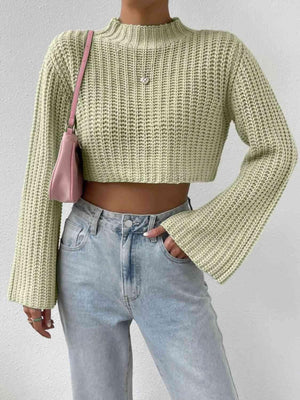 a woman wearing a crop top and jeans