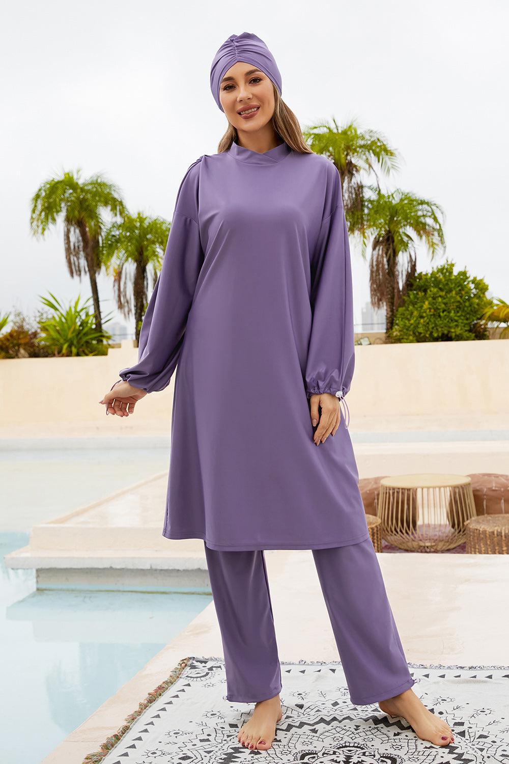 a woman in a purple outfit standing next to a pool