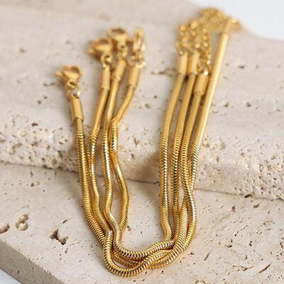 a close up of a pair of gold necklaces