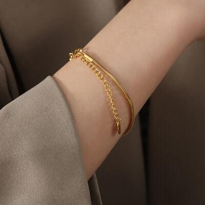 a woman's arm with a gold bracelet on it