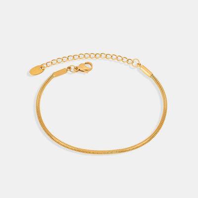 a gold bracelet with a clasp on a white background