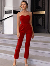 a woman in a red jumpsuit posing for the camera