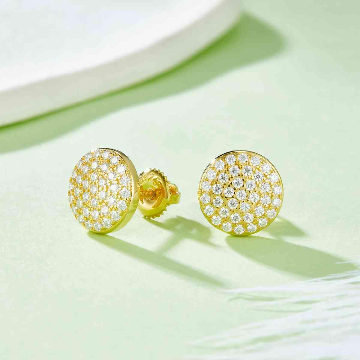 a pair of diamond earrings sitting on top of a table
