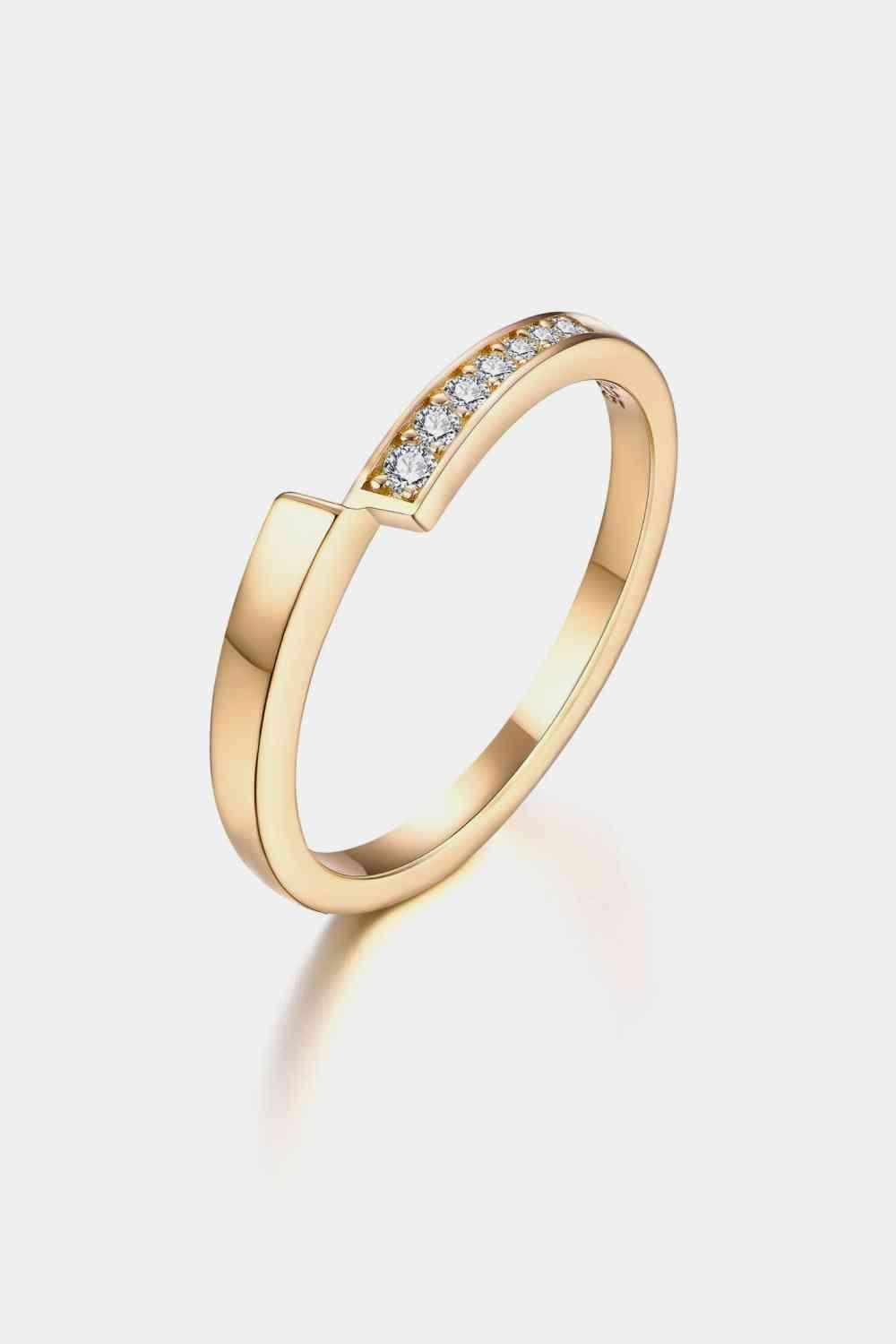 a yellow gold ring with a diamond set in the middle