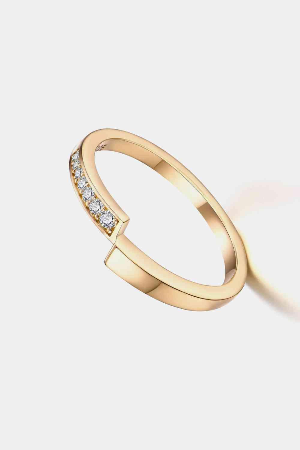 a gold ring with a diamond set in the middle