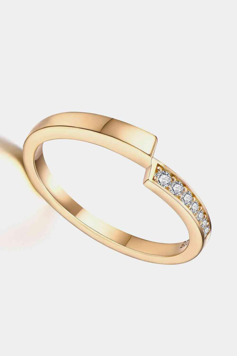 a gold ring with diamonds on a white background