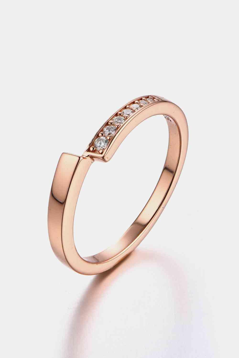 a rose gold ring with diamonds on it