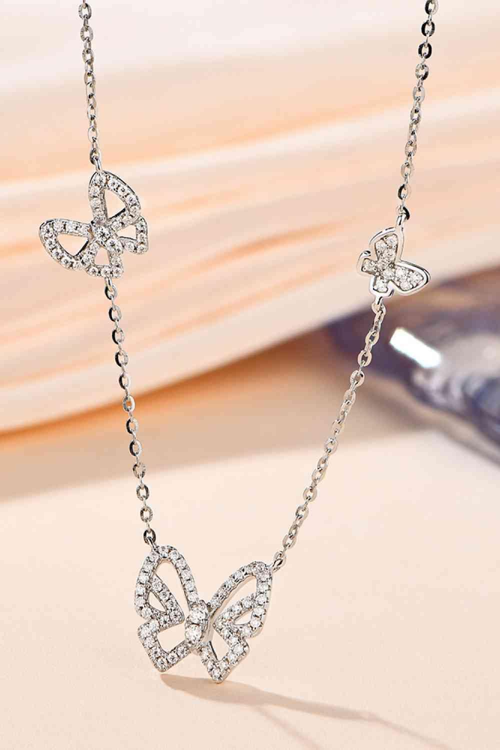 a necklace with a butterfly design on it