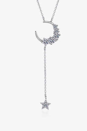a necklace with a crescent and stars hanging from it