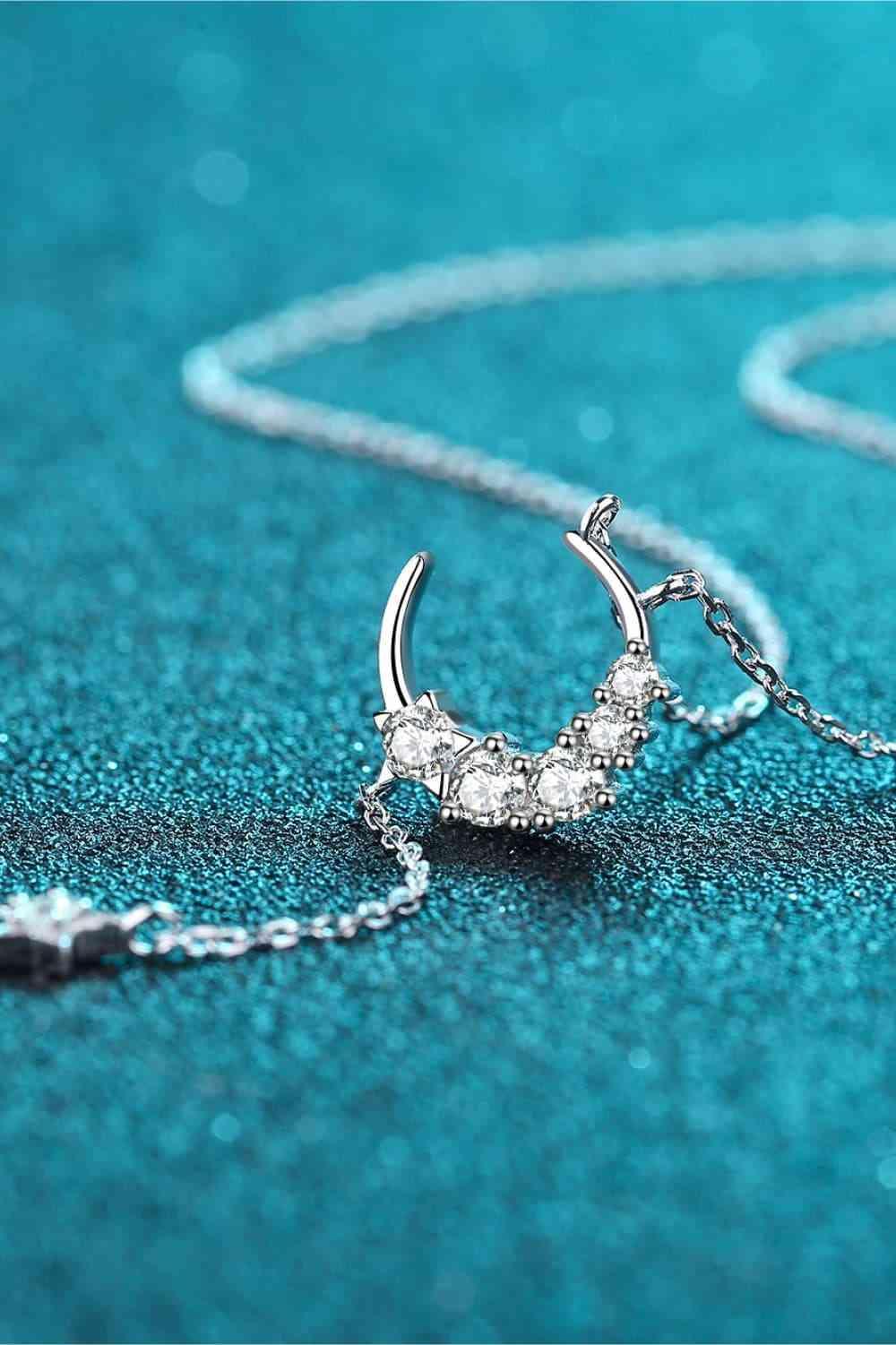 a necklace with a crescent and stars on it