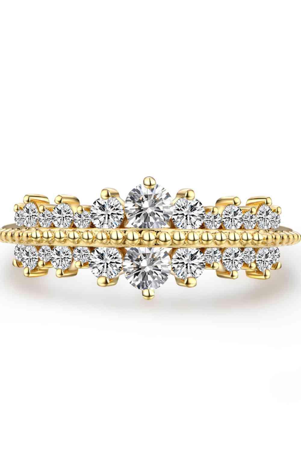 a yellow gold engagement ring set with three stones