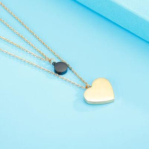 a heart shaped pendant on a chain on a blue background