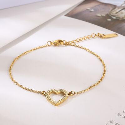 a gold bracelet with a heart on it
