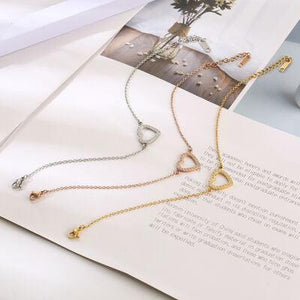 three different necklaces on top of an open book