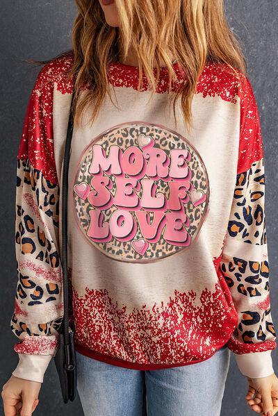 a woman wearing a leopard print sweatshirt with the words more love on it