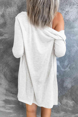 the back of a woman wearing a white sweater