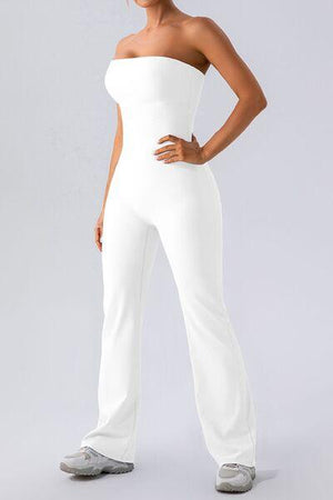 a woman in a white jumpsuit posing for a picture