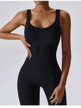 a woman in a black bodysuit with her hands on her hips
