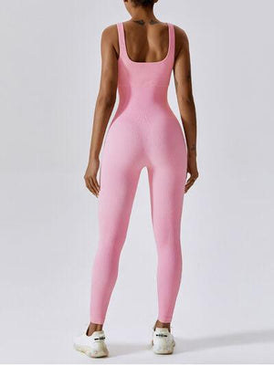 a woman wearing a pink bodysuit and white tennis shoes