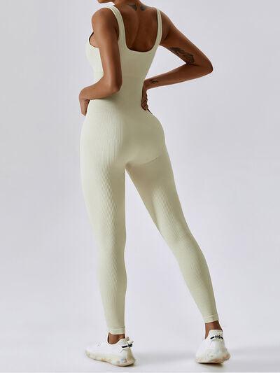 a woman wearing a white bodysuit and white tennis shoes