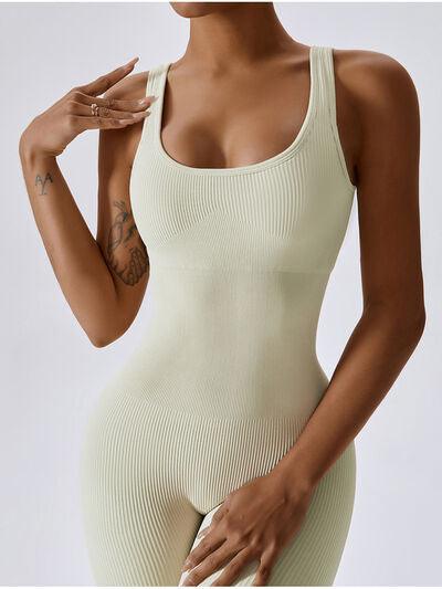 a woman in a white bodysuit posing for the camera