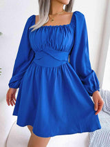 a woman in a blue dress posing for a picture