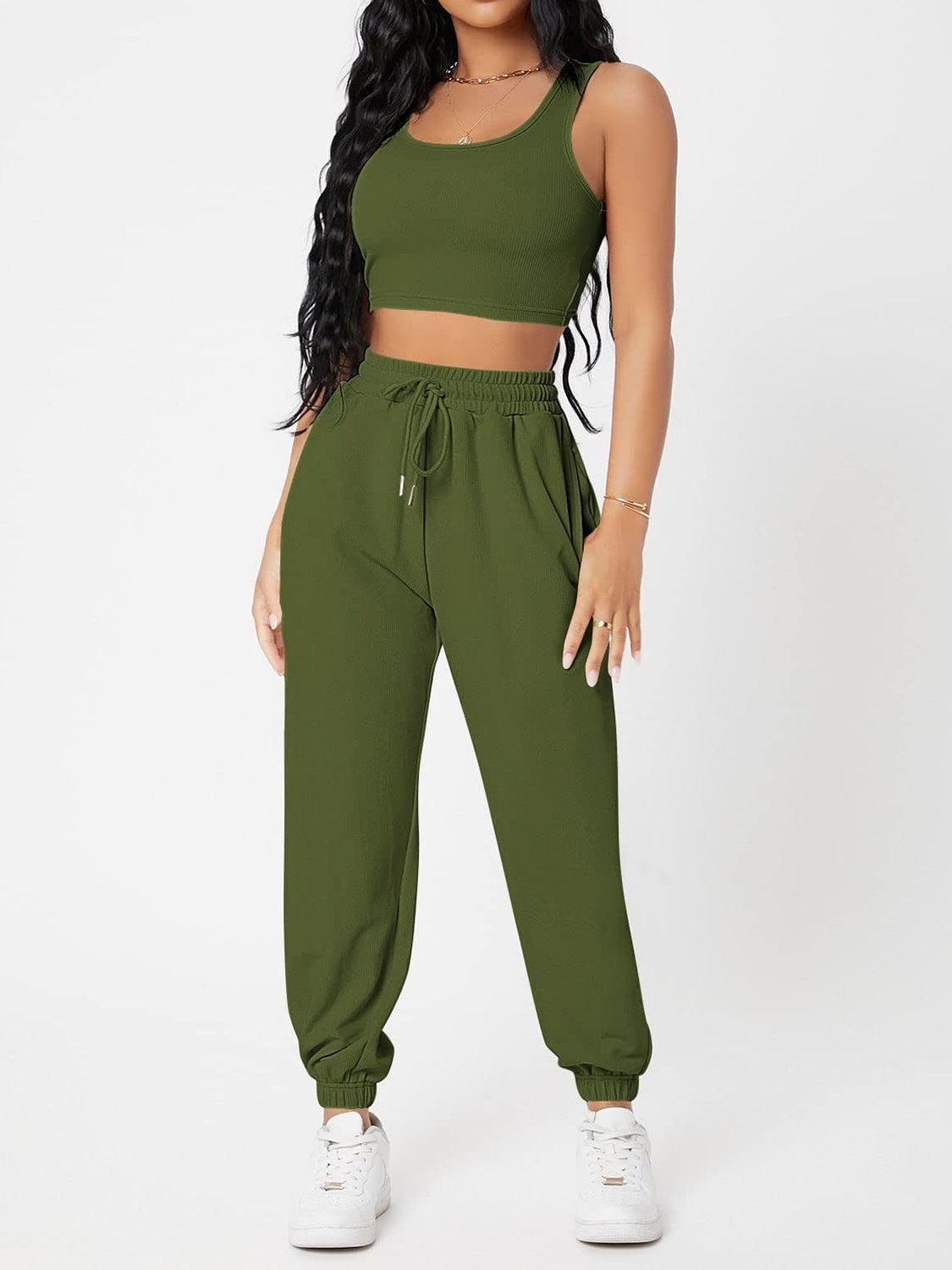 a woman in a crop top and sweat pants