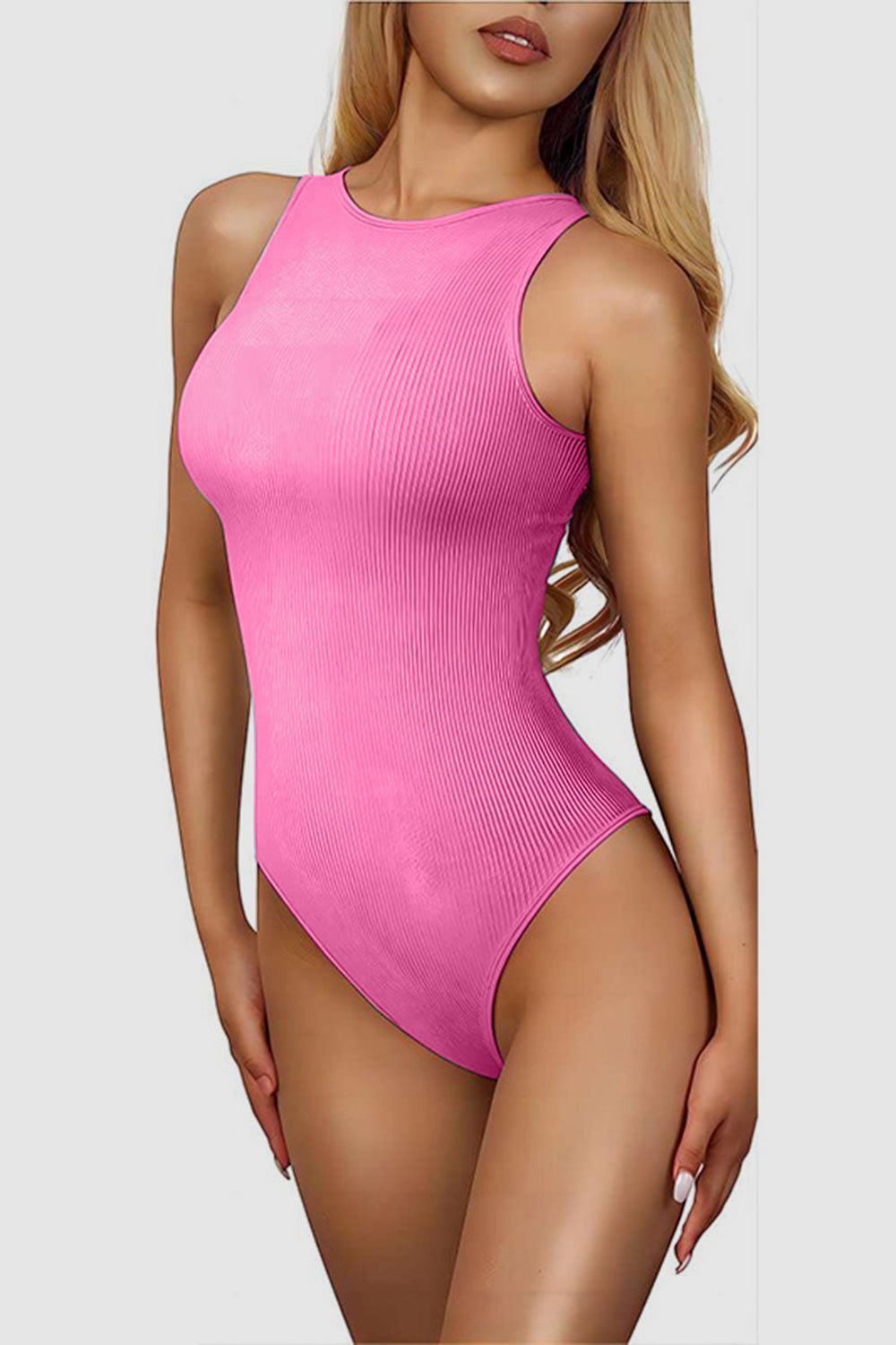 a woman in a pink bodysuit posing for a picture
