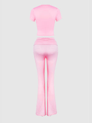 a woman in a pink top and pants