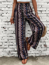 a woman standing in front of a brick wall