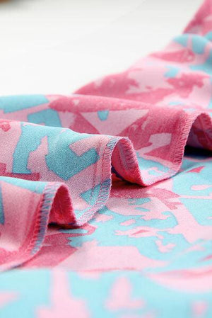 a close up of a pink and blue fabric