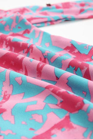 a close up of a pink and blue tie