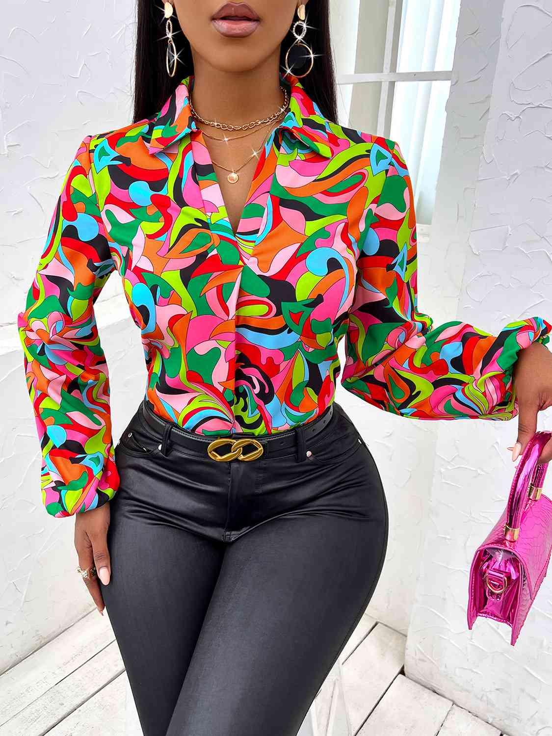 a woman wearing a colorful shirt and black pants