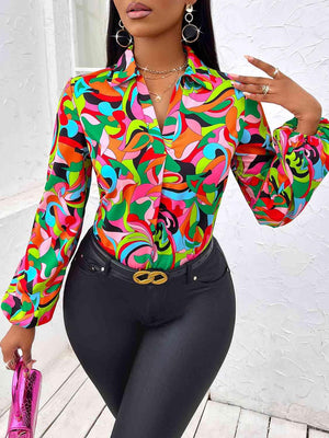 a woman wearing a colorful shirt and black pants