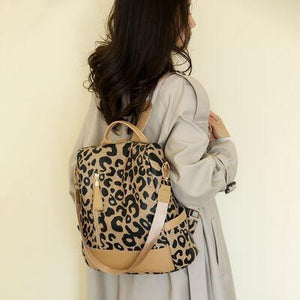 a woman carrying a leopard print purse