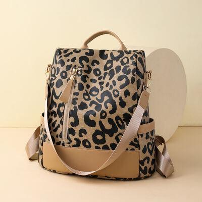 a leopard print bag with a tan strap