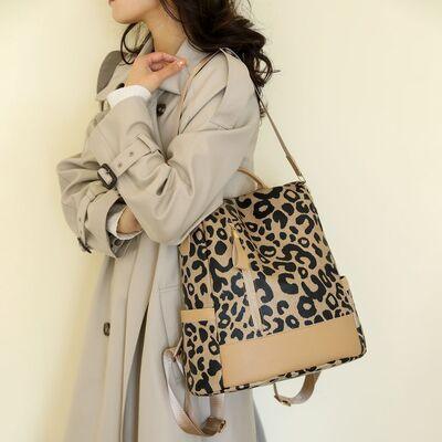 a woman in a trench coat carrying a leopard print purse