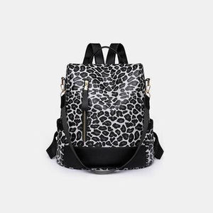 a black and white backpack with a leopard print pattern