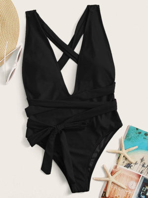 a black one piece swimsuit with a hat and sunglasses
