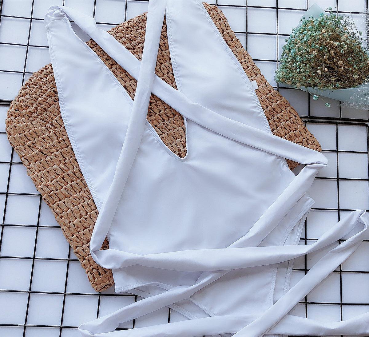 a white piece of clothing laying on top of a tiled floor