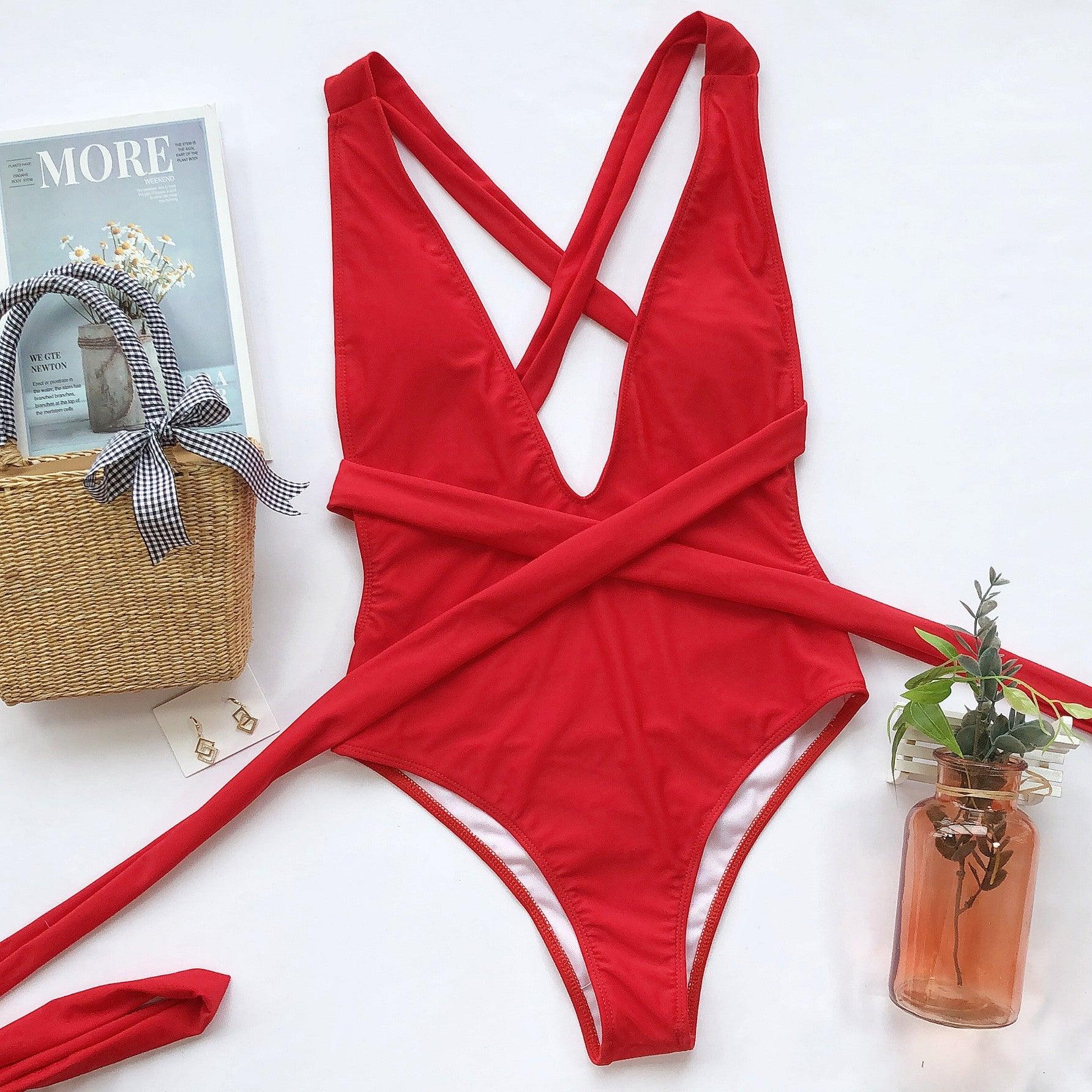 a red one piece swimsuit with a bow at the back