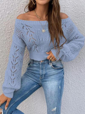 a woman wearing a blue sweater and ripped jeans