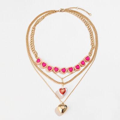 a multi layer necklace with a heart charm