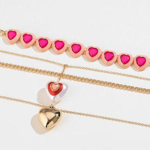 a row of pink and gold hearts on a gold chain
