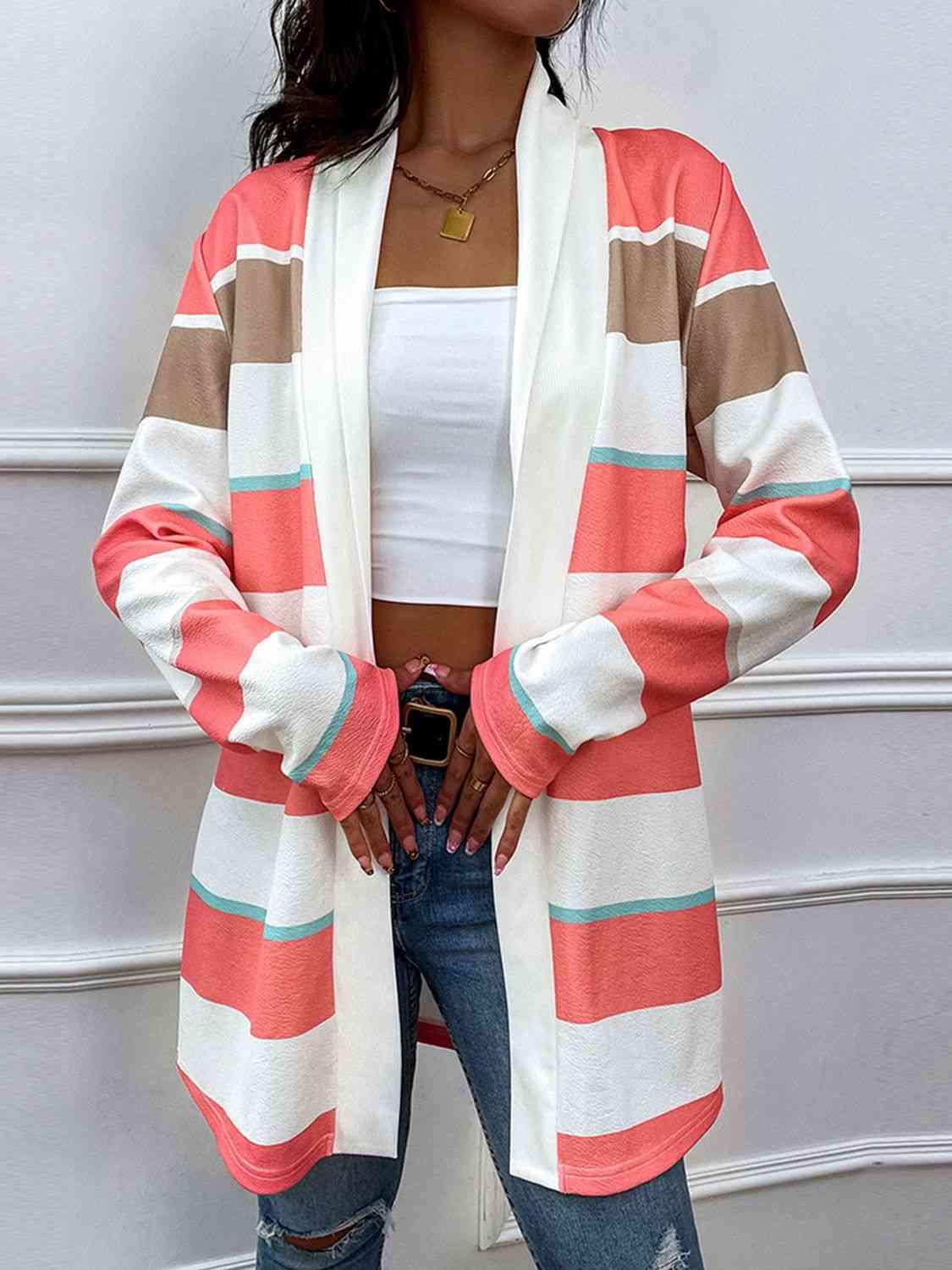 a woman wearing a pink and brown striped cardigan