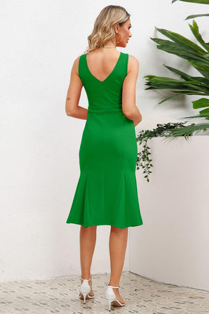 a woman in a green dress looking back