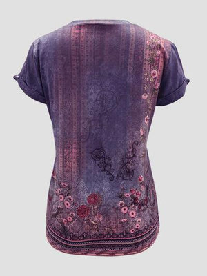 a woman's purple top with a floral design