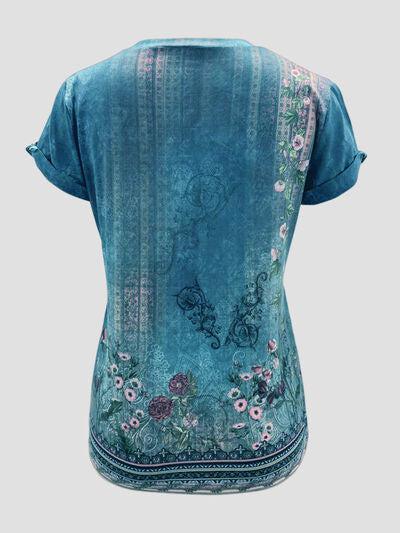 a woman's blue top with flowers on it