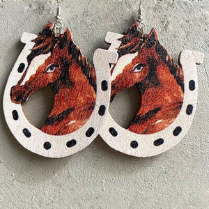 a pair of earrings with a horse on it